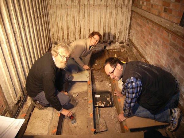 Archaeologists David Roe, left, Annita Waghorn and Martin Gibbs at work in the convict cell