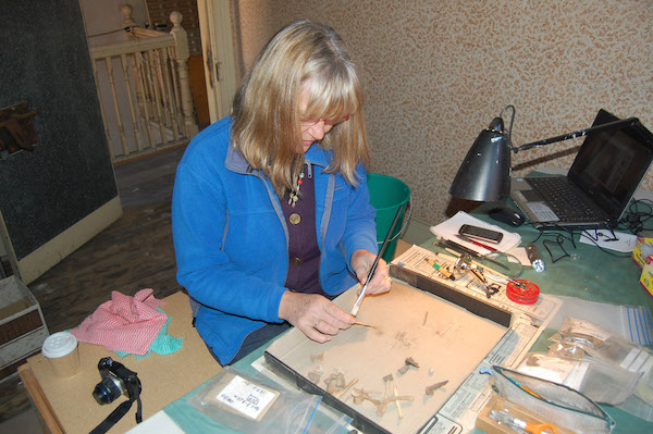 Conservator Linda Clark cleaning artefacts